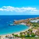 View of Lindos beach with village of Lindos and Acropolis in background (Rhodes, Greece)